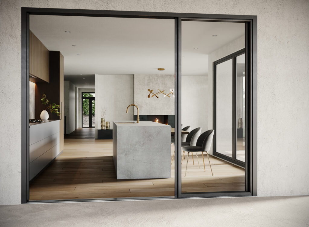 Image looking through a glass patio door, into a kitchen with natural stone elements and wood floor.