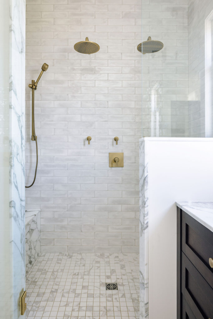 IMage showing the luxury stadup shower with detailed tile work and multiple shower heads.