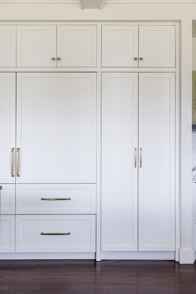 Image showing white cabinets with integrated appliances in the kitchen.