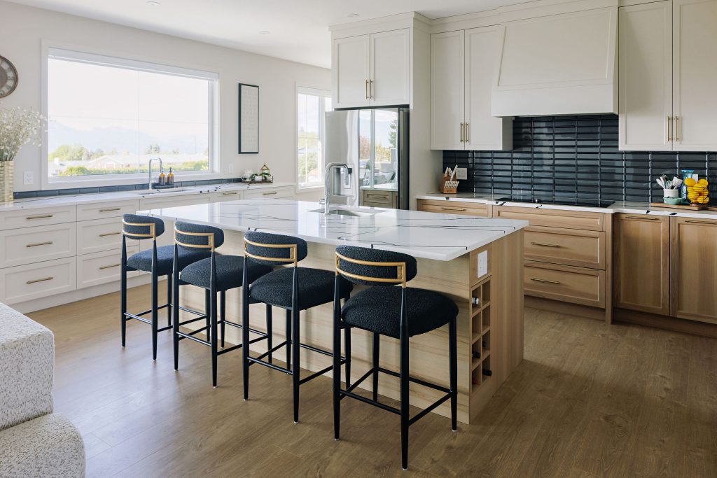 Ogden Road kitchen with a central island, four stools, white cabinets and a dark tile backsplash